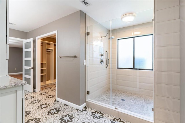 bathroom with vanity and a shower with shower door