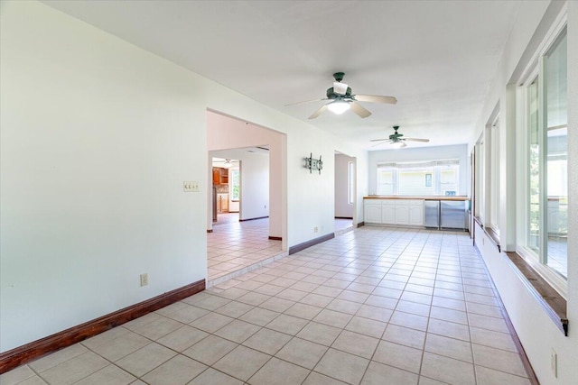 tiled empty room featuring ceiling fan