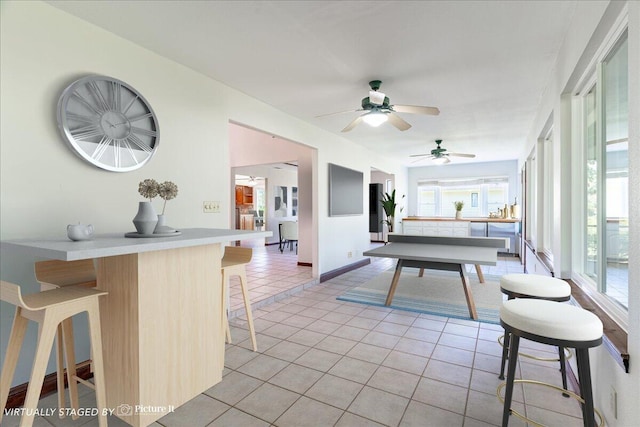 rec room featuring light tile patterned floors and ceiling fan