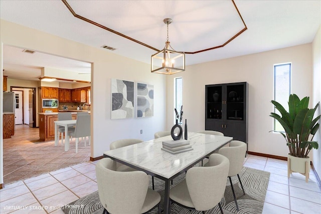 dining area featuring light tile patterned floors and a chandelier