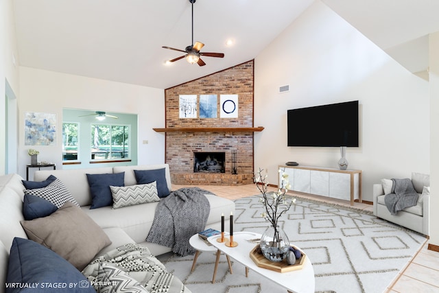 tiled living room with a fireplace, high vaulted ceiling, and ceiling fan