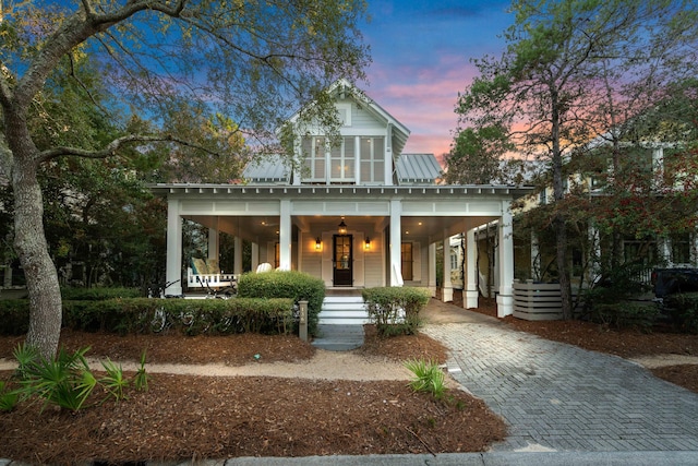 view of front facade with a porch and a carport