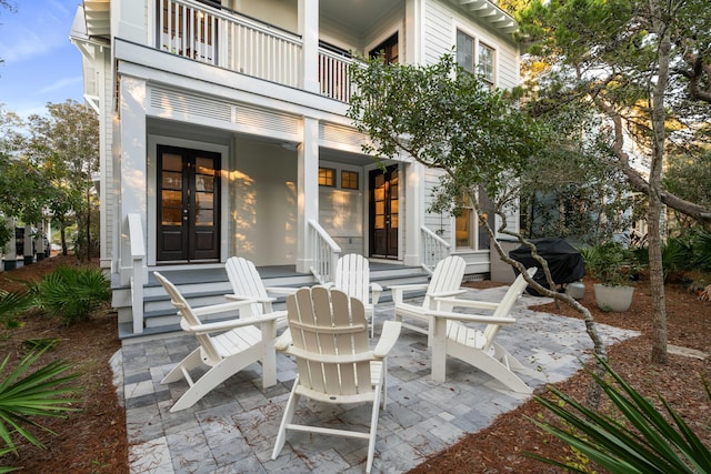 view of patio featuring french doors, a balcony, and area for grilling