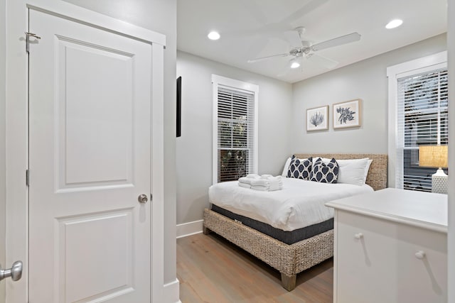 bedroom with ceiling fan and light wood-type flooring