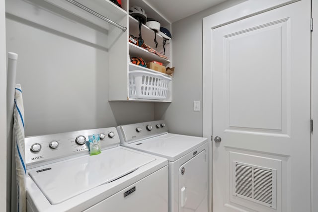 clothes washing area with washing machine and clothes dryer