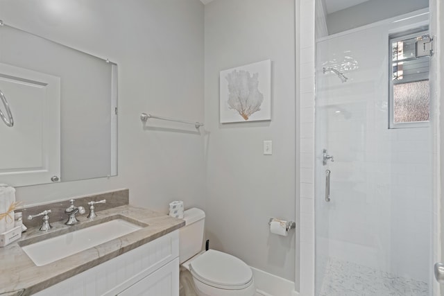 bathroom with vanity, toilet, and a shower with door