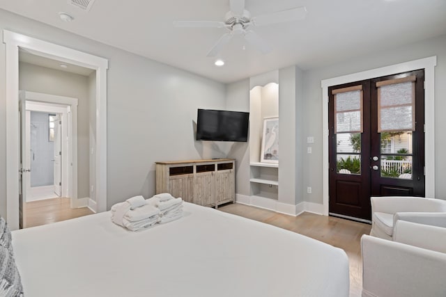 bedroom featuring access to exterior, french doors, ceiling fan, and light wood-type flooring