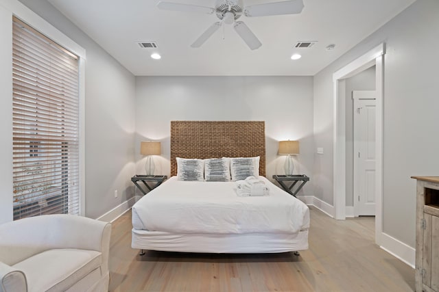 bedroom with ceiling fan and light hardwood / wood-style flooring