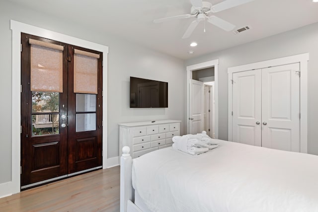 bedroom featuring french doors, ceiling fan, light hardwood / wood-style floors, and a closet