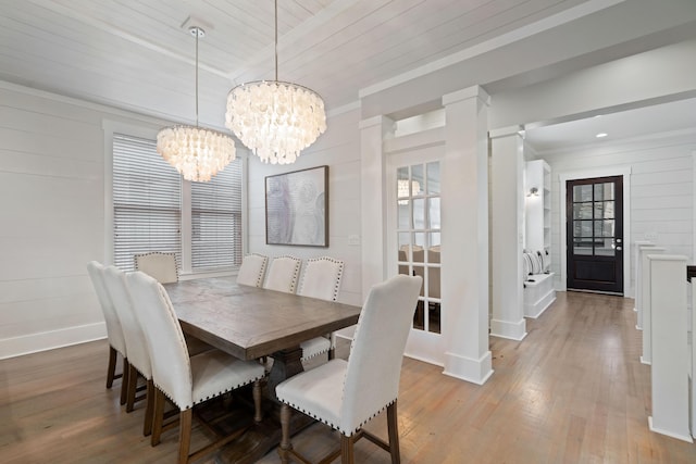 dining space featuring crown molding, a healthy amount of sunlight, and light wood-type flooring