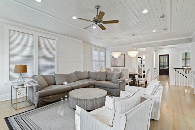 living room with lofted ceiling, wooden ceiling, ornamental molding, light hardwood / wood-style floors, and ceiling fan with notable chandelier