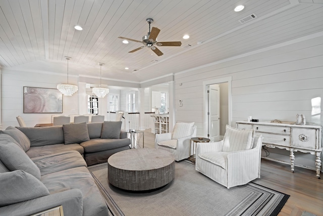 living room featuring lofted ceiling, hardwood / wood-style floors, wood ceiling, and ceiling fan with notable chandelier