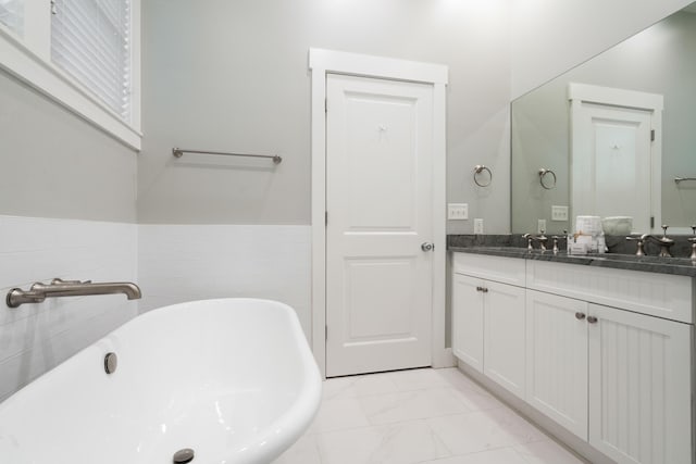 bathroom with vanity and a bathtub