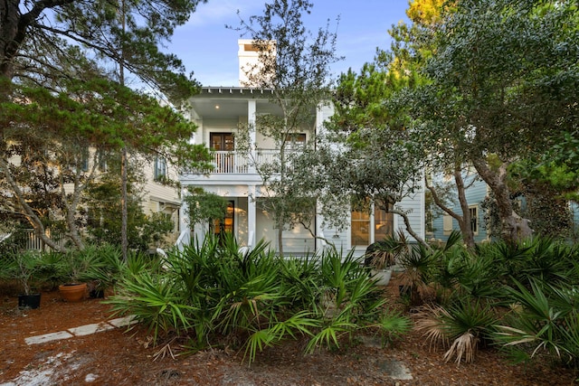 view of front of house featuring a balcony