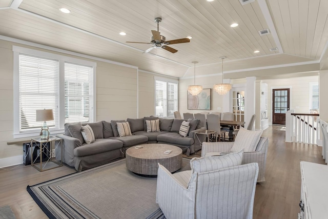 living room with wood-type flooring, lofted ceiling, wood ceiling, a raised ceiling, and crown molding