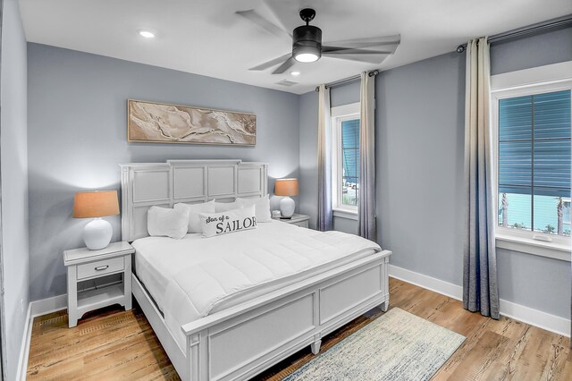 bedroom with ceiling fan and light hardwood / wood-style floors