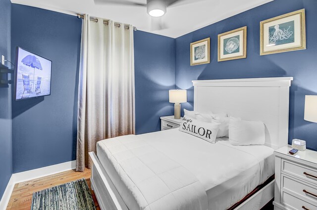 bedroom with light hardwood / wood-style flooring and ceiling fan