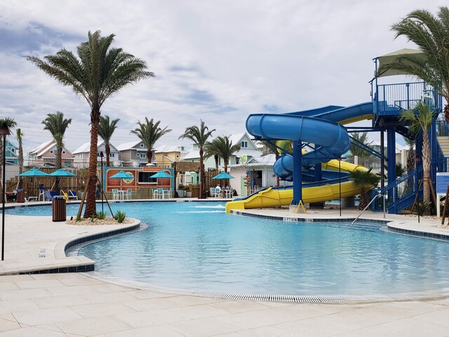 view of pool with a patio area and a water slide