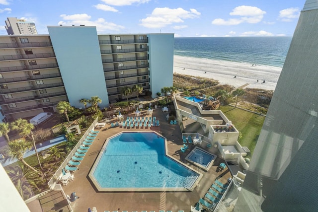 birds eye view of property with a water view and a beach view