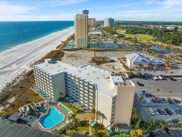 bird's eye view featuring a water view and a beach view