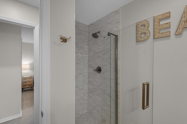 bathroom with a shower with door