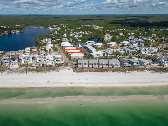 bird's eye view featuring a water view and a beach view