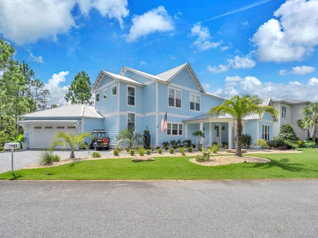 view of front of home with a front lawn and a garage