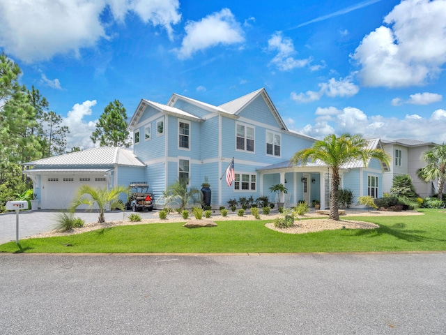 view of front of property featuring a garage and a front yard