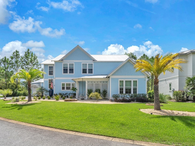 61 Sweet Breeze Dr, Santa Rosa Beach, FL 32459 - view of front of home featuring a front lawn, metal roof, and a standing seam roof