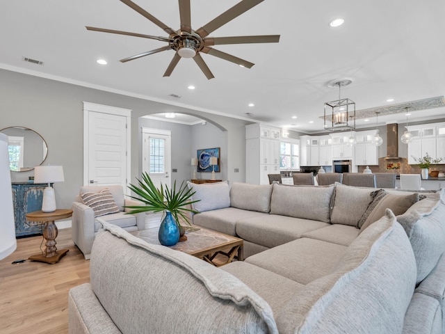 61 Sweet Breeze Dr, Santa Rosa Beach, FL 32459 - living room with arched walkways, a ceiling fan, recessed lighting, healthy amount of natural light, and light wood-style flooring