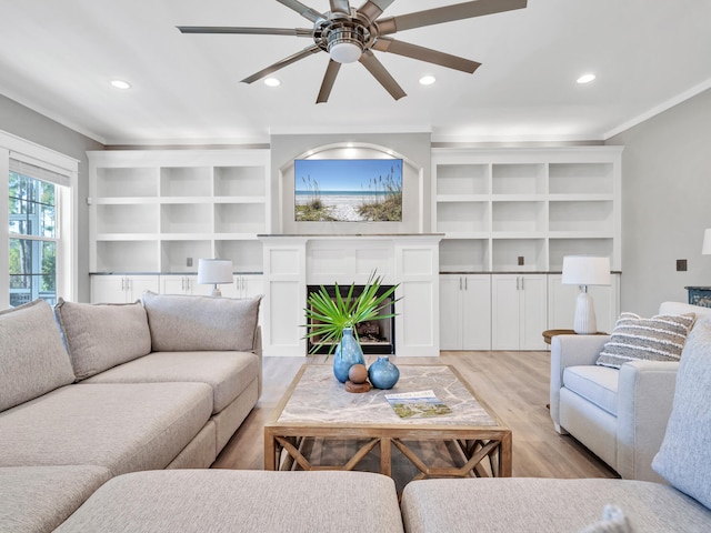 61 Sweet Breeze Dr, Santa Rosa Beach, FL 32459 - living room featuring light wood-type flooring, a fireplace, a ceiling fan, crown molding, and recessed lighting