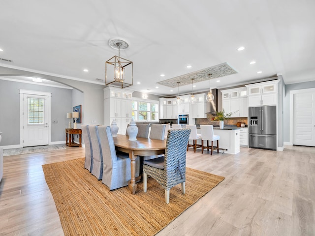 61 Sweet Breeze Dr, Santa Rosa Beach, FL 32459 - dining room with healthy amount of natural light, baseboards, arched walkways, light wood-type flooring, and ornamental molding