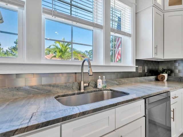61 Sweet Breeze Dr, Santa Rosa Beach, FL 32459 - kitchen featuring a sink, white cabinets, decorative backsplash, and light stone countertops