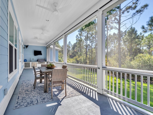 61 Sweet Breeze Dr, Santa Rosa Beach, FL 32459 - sunroom with ceiling fan, outdoor dining area, and exterior kitchen