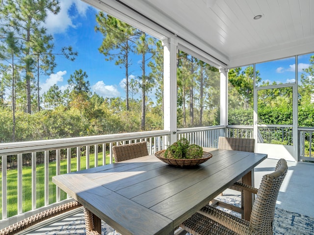 61 Sweet Breeze Dr, Santa Rosa Beach, FL 32459 - sunroom featuring outdoor dining space and view of scattered trees