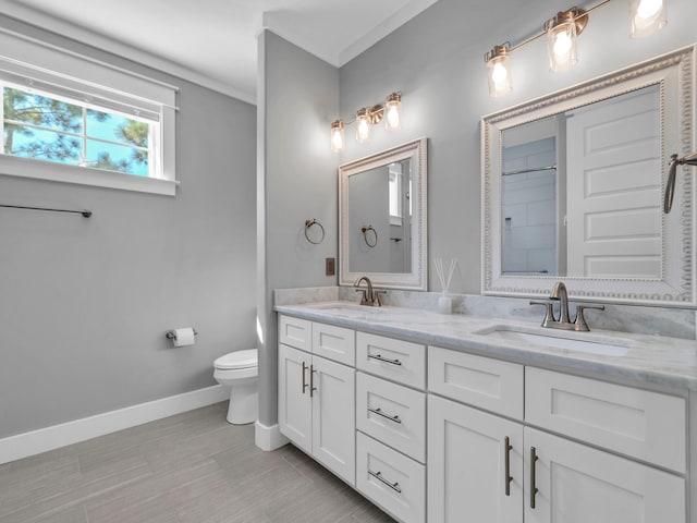 61 Sweet Breeze Dr, Santa Rosa Beach, FL 32459 - bathroom featuring baseboards, toilet, double vanity, a shower, and ornamental molding