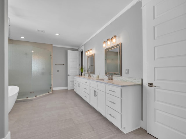 61 Sweet Breeze Dr, Santa Rosa Beach, FL 32459 - full bathroom featuring a shower stall, double vanity, recessed lighting, baseboards, and crown molding