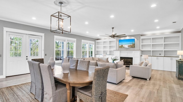 61 Sweet Breeze Dr, Santa Rosa Beach, FL 32459 - dining space with ornamental molding, light wood finished floors, recessed lighting, a ceiling fan, and a glass covered fireplace