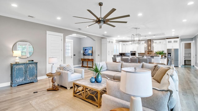 61 Sweet Breeze Dr, Santa Rosa Beach, FL 32459 - living area featuring ceiling fan, arched walkways, recessed lighting, light wood-style floors, and baseboards