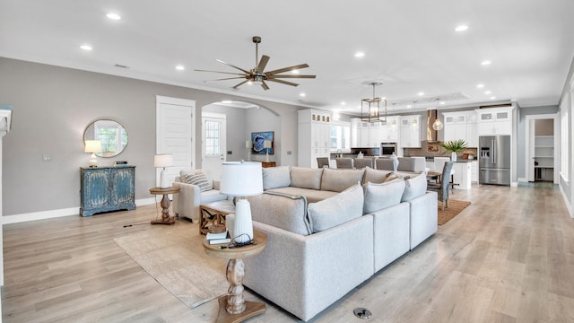 61 Sweet Breeze Dr, Santa Rosa Beach, FL 32459 - living area with arched walkways, recessed lighting, ceiling fan, baseboards, and light wood-type flooring