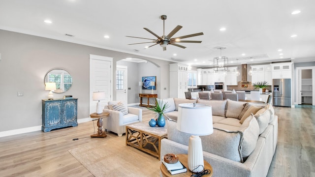 61 Sweet Breeze Dr, Santa Rosa Beach, FL 32459 - living area featuring arched walkways, recessed lighting, baseboards, ceiling fan, and light wood finished floors