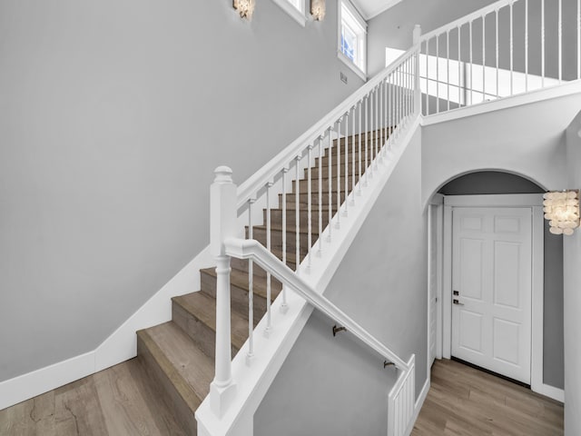 61 Sweet Breeze Dr, Santa Rosa Beach, FL 32459 - staircase with wood finished floors and a towering ceiling