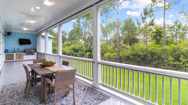 61 Sweet Breeze Dr, Santa Rosa Beach, FL 32459 - sunroom / solarium with ceiling fan, outdoor dining area, and view of scattered trees