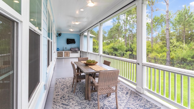 61 Sweet Breeze Dr, Santa Rosa Beach, FL 32459 - sunroom / solarium with outdoor dining space and view of scattered trees