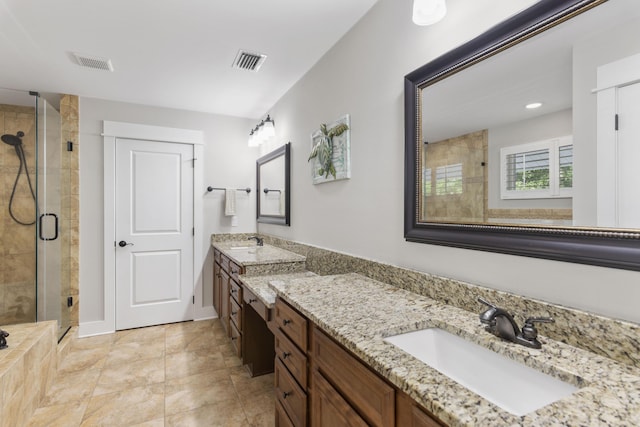 bathroom featuring a shower with door and vanity