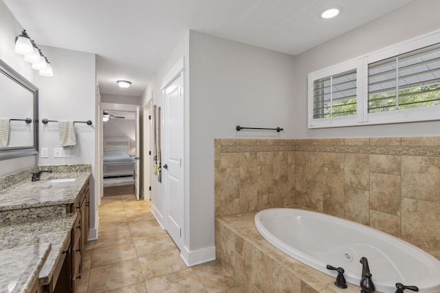 bathroom with vanity, tile patterned flooring, and tiled bath