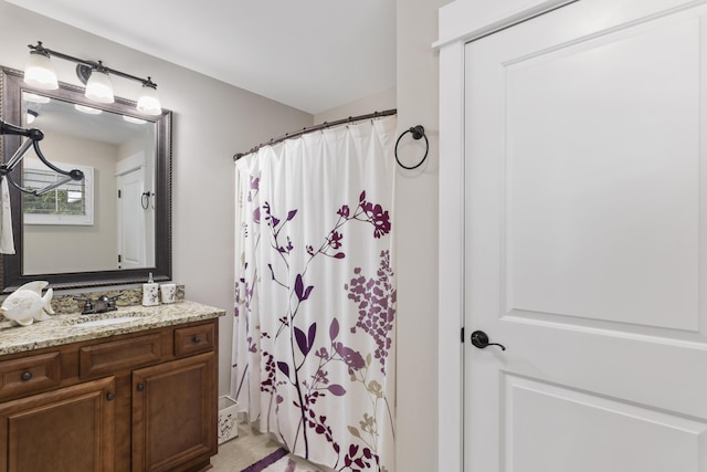 bathroom featuring vanity and curtained shower