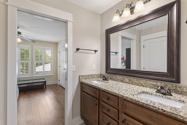 bathroom with vanity, hardwood / wood-style flooring, and ceiling fan