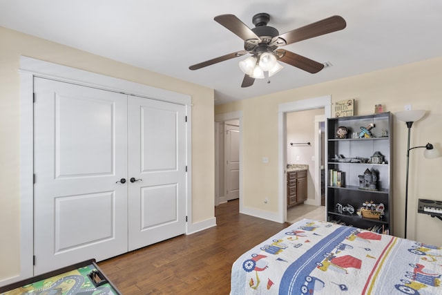 bedroom with dark hardwood / wood-style floors, connected bathroom, ceiling fan, and a closet