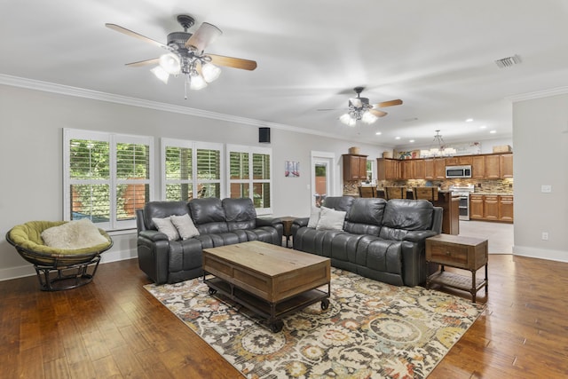 living room with crown molding, ceiling fan with notable chandelier, and dark hardwood / wood-style floors